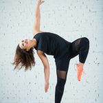 Curly woman dancing contemporary at fitness class